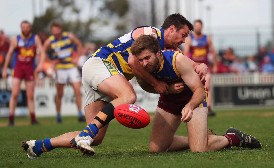 300 UP: MCUE's Trent Cohalan tackles Josh Walsh during a game against GGGM last season. Picture: Emma Hillier