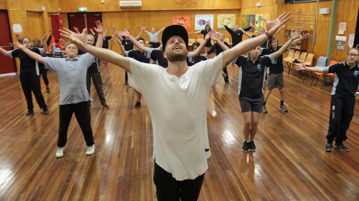 Jarryd Byrne teaches students at Mount Austin High School to dance in 2016. Picture: Les Smith