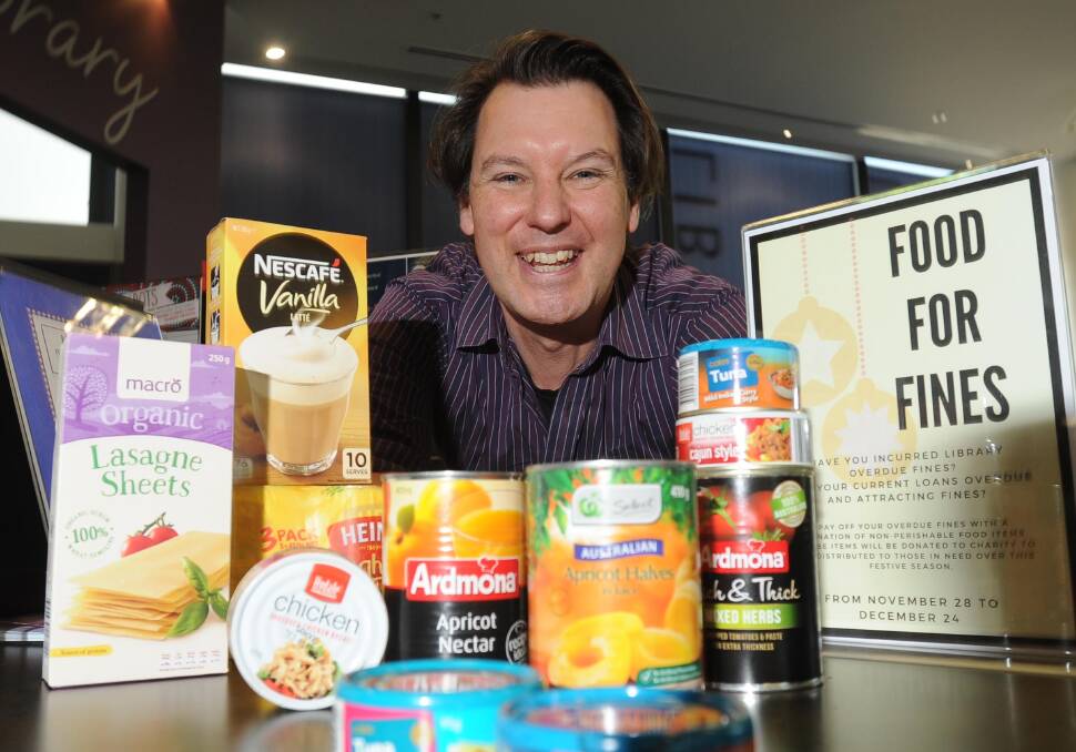 FOOD FOR FINES: Programs officer Peter Casey is encouraging Wagga residents to pay off their library fines with food donations. Picture: Laura Hardwick 