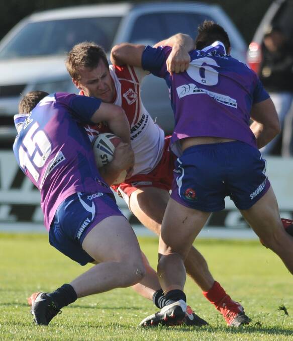 TOUGH TUSSLE: Southcity pair Josh Cochrane and Nathan Rose work to bring down Temora centre Matt Hughes in the big win by the Bulls at Harris Park on Sunday. Picture: Laura Hardwick