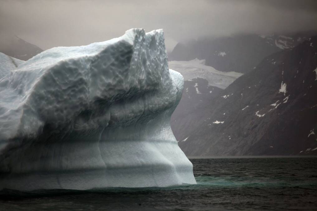 A melting iceberg floats along a fjord leading away from the edge of the Greenland ice sheet near Nuuk, Greenland. Photo: AP Photo/Brennan Linsley, File