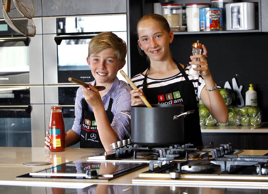 MASTER CHEFS: Twins Hugh and Claire Robinson, 12, will further their culinary skills during a junior cooking class today. Picture: Les Smith 