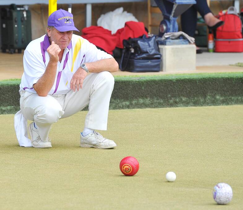 RICH HISTORY: Trevor Firman from Temora Bowling and Recreation Club checks the lie of bowls during the 2015 Bing Wallder Shield.