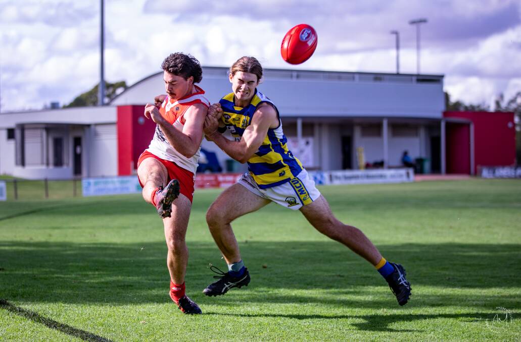 JUST IN TIME: Griffith's Reece Matheson gets the ball away before being closed down by the Mangoplah-Cookardinia United-Eastlakes' Justin Dore in the Riverina League game at Exies Oval on Saturday. Picture: Andrew McLean.