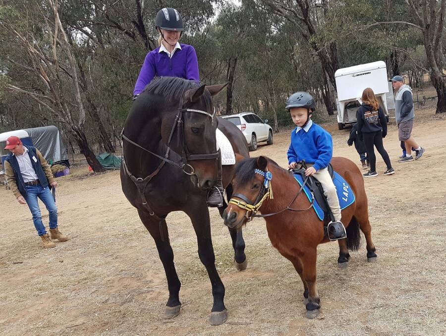 FUN: Christopher Ip and Marky from Lake Albert Pony Club (right) seek some advice from older camper Sophie O’Connor and Colin from Wirlinga and District Pony Club.