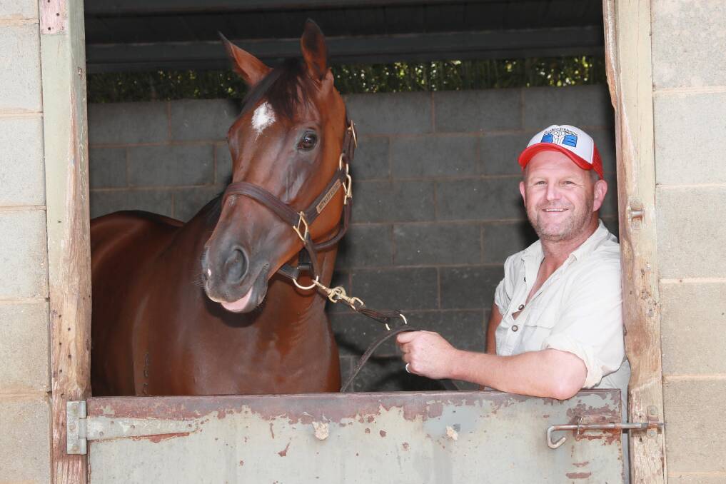 GOING STRONG: Wagga trainer Chris Heywood with his in-form mare Coves at his stables on Tuesday. Picture: Les Smith