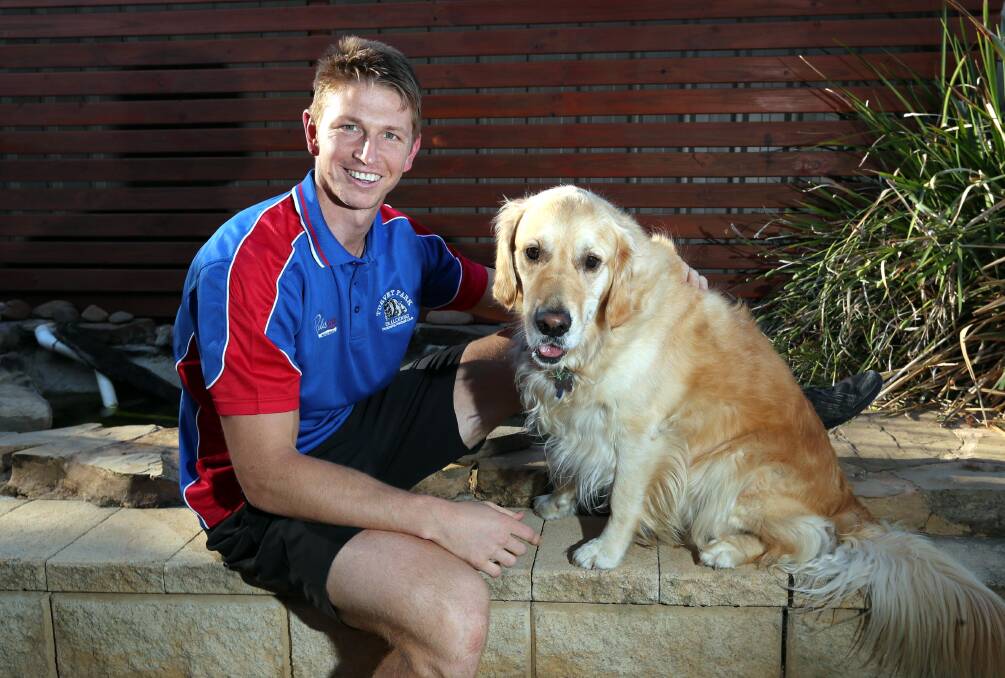 Nathan Byrne at home with his dog Tex on Thursday. Picture: Les Smith
