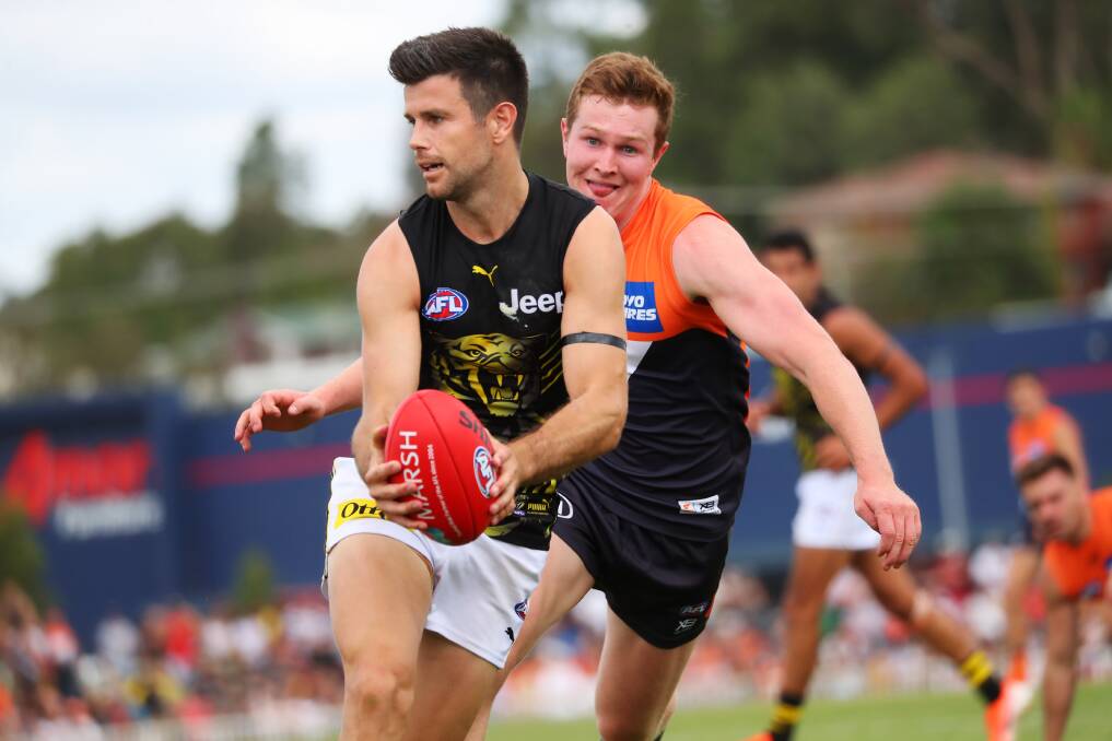 IN DOUBT: Richmond captain Trent Cotchin looks to fire off a handball in the pre-season game at Robertson Oval last year. Picture: Emma Hillier
