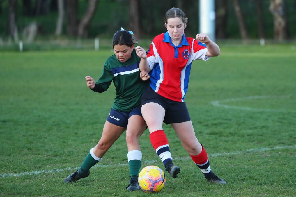 IN DOUBT: The Riverina Anglican College's Tootsie Lamb and Kildare Catholic College's Eleanore Crawford compete in the Shipard Shield semi-final at Rawlings Park last Monday night. Picture: Emma Hillier
