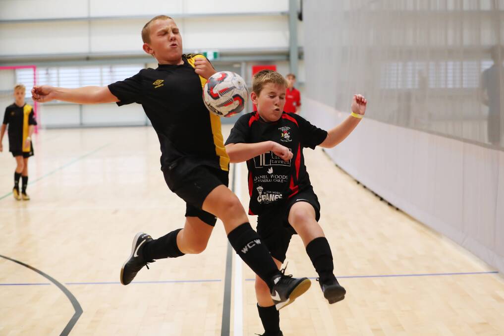 NO HOLDING BACK: ARTL Driller's Jack Warden and Karate Flying Chickens' Riley Schofield compete in the under 14 grand final of last year's Wagga Futsal Cup. Picture: Emma Hillier