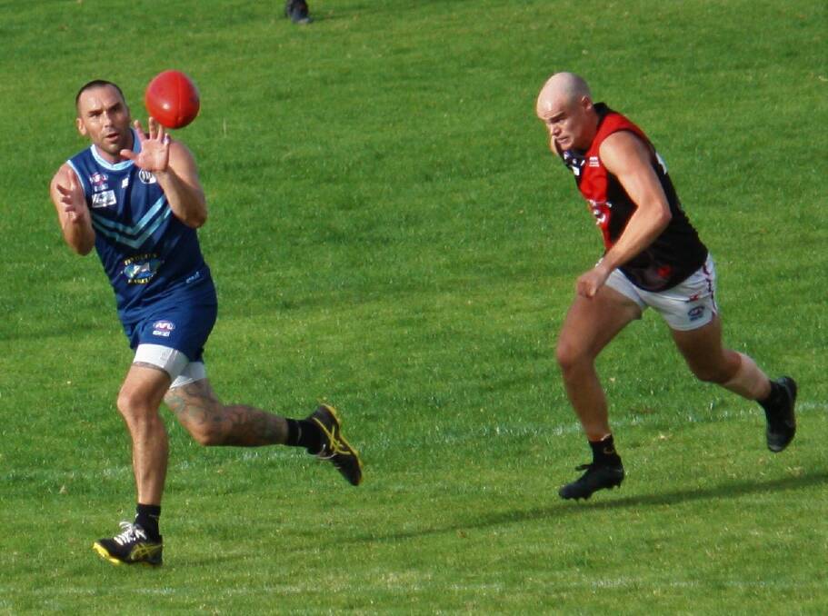 ON THE REBOUND: Barellan coach Alex Lawder leads Marrar's Billy Toy to the ball last Saturday. Picture: Barellan Two Blues