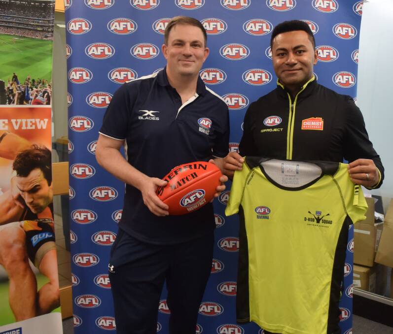 SPECIAL VISIT: AFL Southern NSW umpire coordinator Troy Mavorudis with David Rodan at AFL House in Wagga on Wednesday. Picture: Matt Malone