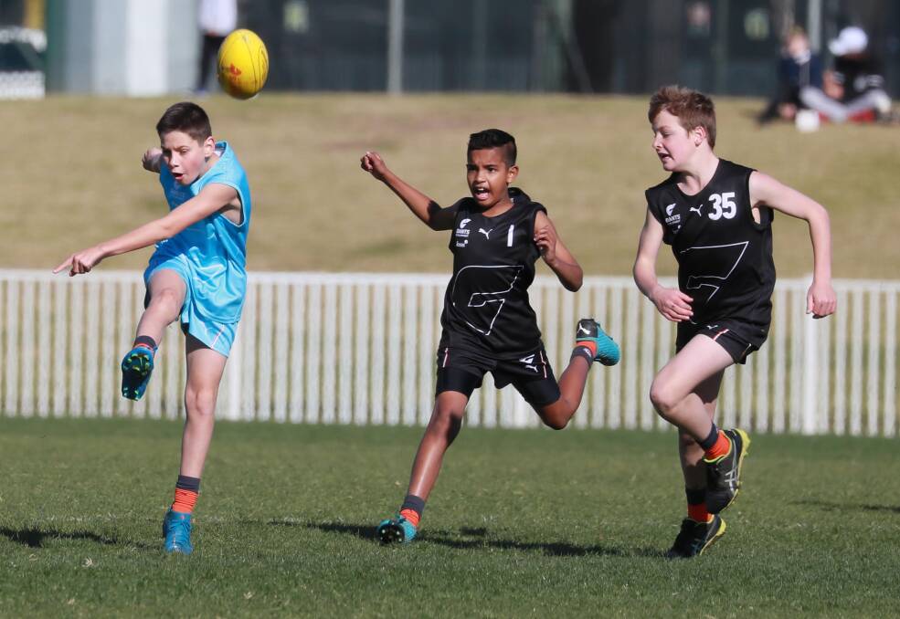 THUMP: MIA's Jacob Dalo gets his kick away despite pressure from Albury-Tocumwal's Samad Mohammed and Oscar Wren in the under 12 boys game at the Southern NSW Giants development day at Robertson Oval on Wednesday. Picture: Les Smith