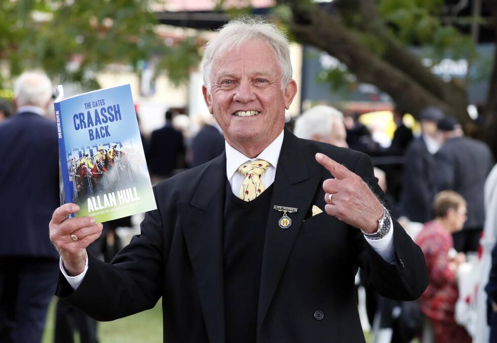 ONE OF A KIND: Retired racecaller Allan Hull shows off his autobiography 'The Gates Craassh Back' that he launched at the Wagga Gold Cup. Picture: Les Smith