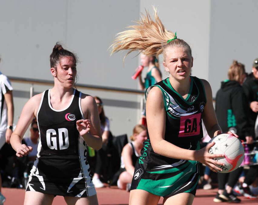 ON THE MOVE: Wagga's Abbey Reinhold beats Cowra's Annaliese Prescott to the ball in a 17 years game at the Wagga Netball Representative Carnival on Sunday. Picture: Les Smith