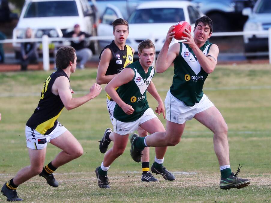 ON THE ATTACK: Coolamon ruckman Ben Edyvean steams through the midfield in the Riverina League game against Wagga Tigers on Saturday. Picture: Emma Hillier