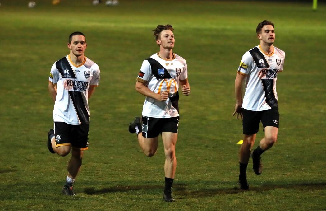 Wagga City Wanderers players go through their paces at training on Thursday night. Picture: Les Smith