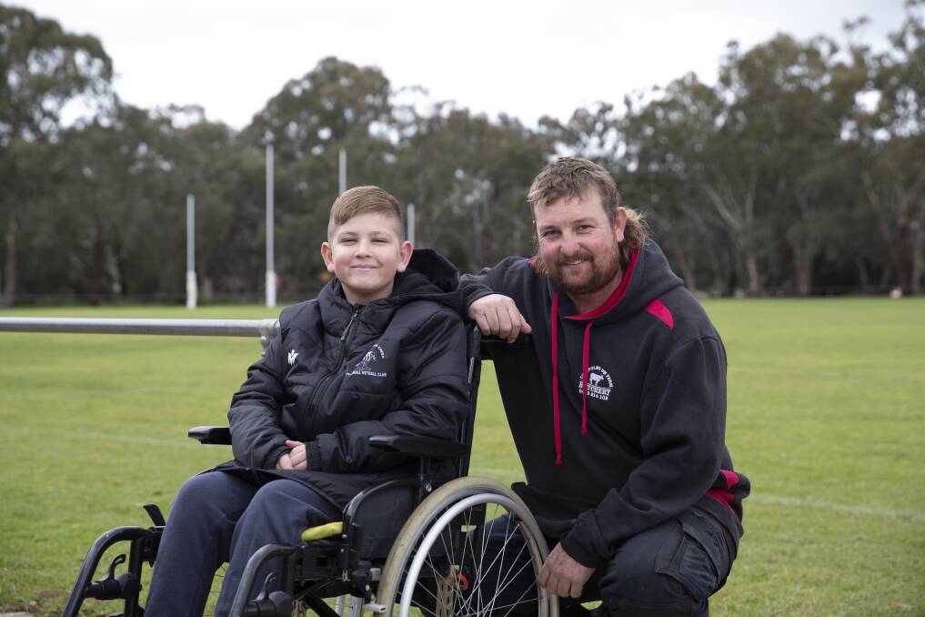 STRONG SUPPORT: Nine-year-old Chance Jones with The Rock-Yerong Creek's Dale Hugo ahead of the Second Chance Silent Auction that will form part of a huge day at The Rock Recreation Ground on Sunday. Picture: Madeline Begley