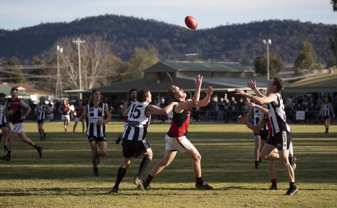 UP FOR GRABS: Marrar's Liam James competes with The Rock-Yerong Creek pair Aiden Ridley and Scott Wolter in the Farrer League game at Victoria Park on Sunday. Picture: Madeline Begley