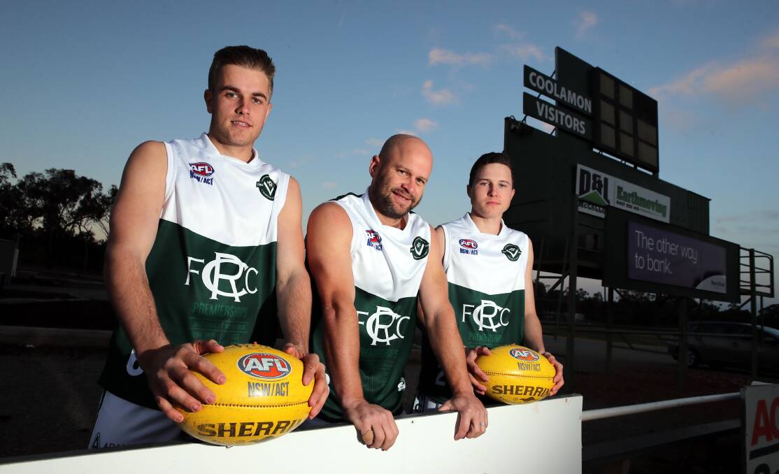 PROUD: Coolamon's Cooper McKelvie, co-coach Jamie Maddox and Braeden Glyde show off the club's special heritage jumper at training on Thursday night that will be worn against Mangoplah-Cookardinia United-Eastlakes on Saturday. Picture: Les Smith