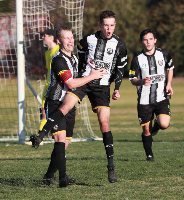 CELEBRATION: Wagga City Wanderers' Zac Pinney is congratulated by co-captain Carl Pideski after finding the back of the net in the 3-0 win over Brindabella at Gissing Oval on Saturday. Picture: Les Smith