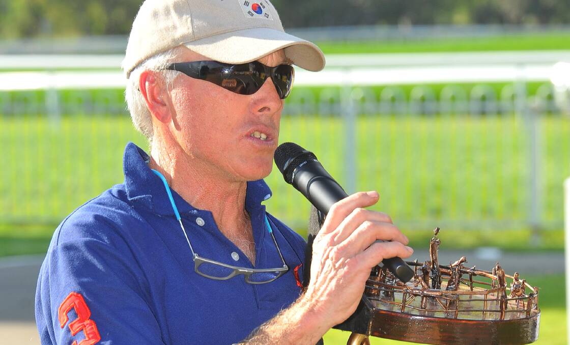 COOL, CALM AND COLLECTED: Gundagai trainer Jim Scobie accepts the Snake Gully Cup on Friday after Zero To Ten's victory. Pictures: Kieren L Tilly