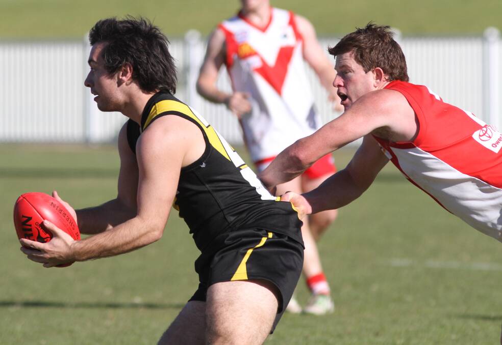 Josh Larwood tries to escape Mick Duncan in a game back in 2013. Picture: Les Smith