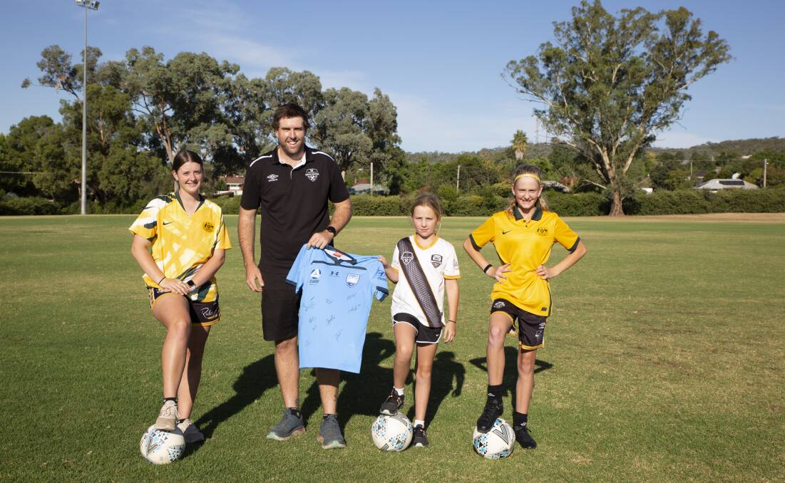 EXCITING TIMES: Ella Barrell, 15, Andi Fields, 10, and Taylor Marshall, 11, with Football Wagga development officer Liam Dedini ahead of Sunday's Female Football Festival at Gissing Oval. Picture: Madeline Begley