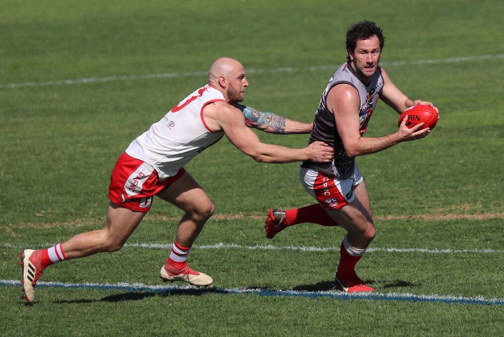 ON SONG: Collingullie-Glenfield Park forward Marc Geppert tries to get away from Griffith defender Guy Orton in the second semi-final at Narrandera Sportsgroudn on Saturday. Picture: Les Smith