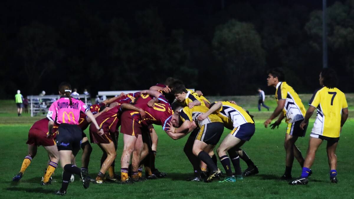 Mater Dei Catholic College and Kooringal High School lock down for a scrum on Monday night. Picture: Emma Hillier