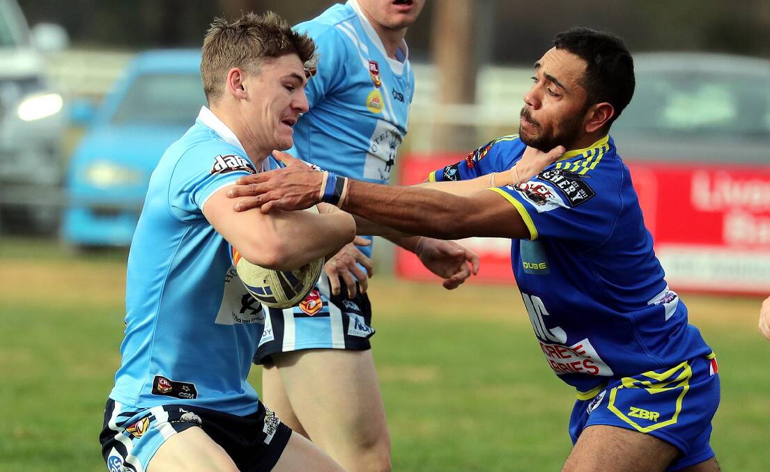 Tristan Dickson tries to stop Brayden Draber playing for Junee last season.