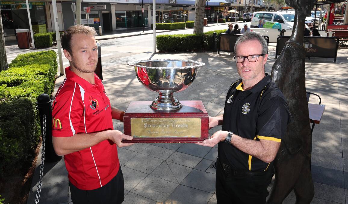 FACE OFF: Griffith coach Will Griggs and Wagga Tigers counterpart Troy Maiden square off with the Riverina League premiership cup in Wagga on Thursday. Picture: Les Smith