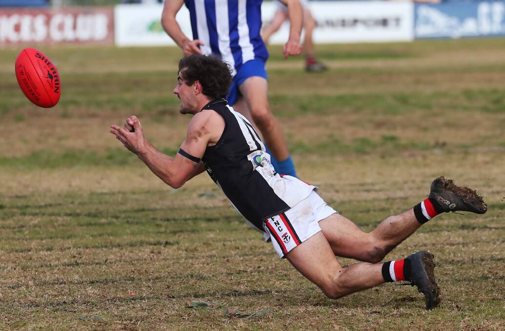 BIG YEAR: North Wagga midfielder Cayden Winter dishes out a handball against Temora earlier in the month. He won the Farrer League's Player of the Year award. Picture: Emma Hillier