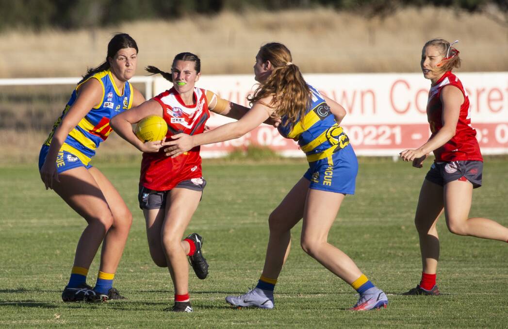 TAKING THEM ON: Collingullie-Glenfield Park's Sidonie Carroll breaks a couple of tackles in Friday night's win over MCUE. Picture: Madeline Begley