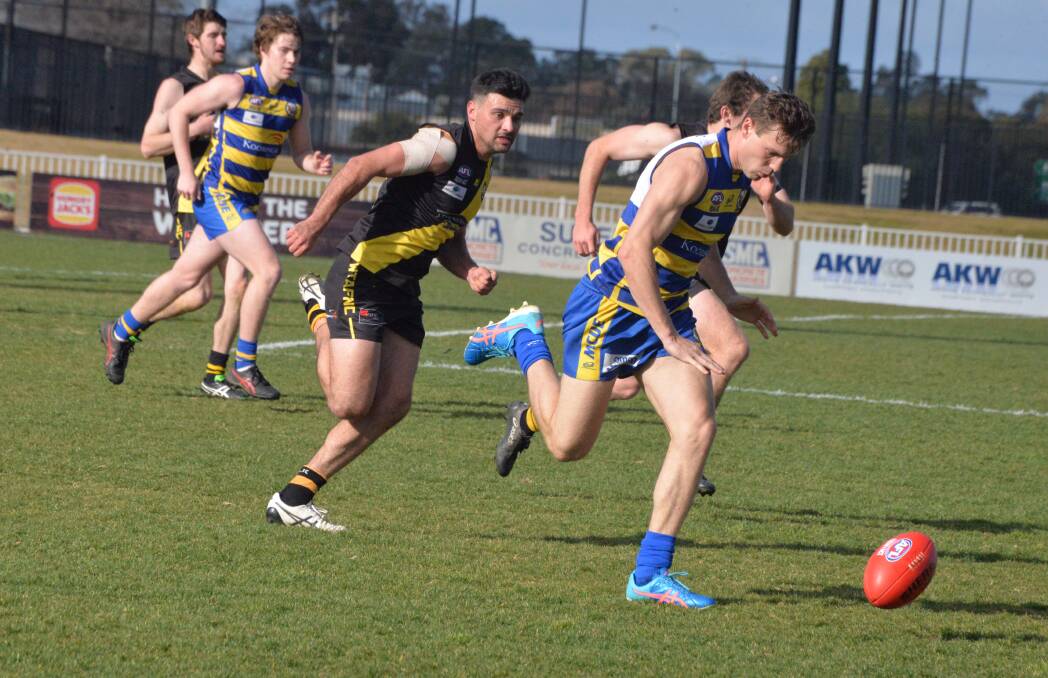 PURSUIT: Wagga Tigers' Lahn Shepherd is hot on the heels of MCUE's Tom Keogh in Saturday's Riverina Football League draw at Robertson Oval, Wagga.