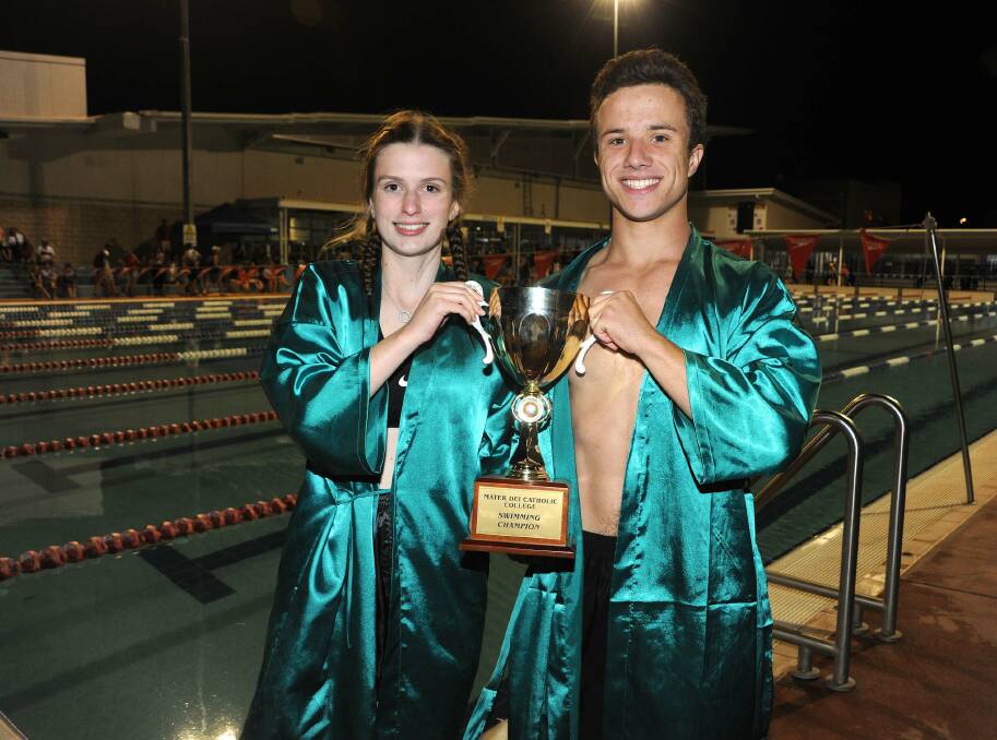 NUMBER ONE: Webber house captains Charlotte Dedini and Wilson Hamblin show off the trophy from the Mater Dei Catholic College swimming carnival on Thursday night. Picture: Kylie Shaw
