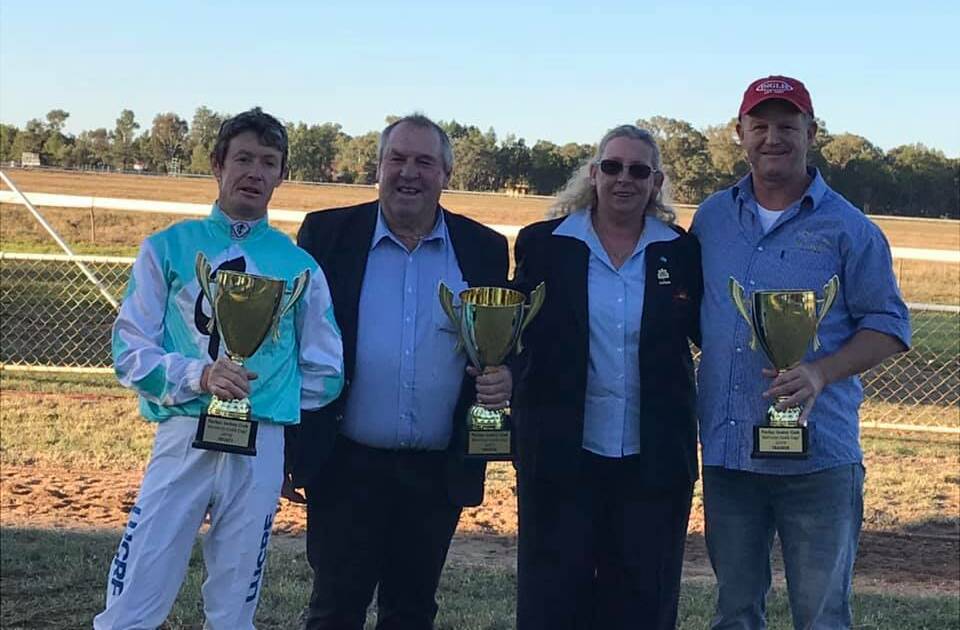 DONE IT AGAIN: Wagga trainer Chris Heywood (right) and jockey Mathew Cahill (left) get the spoils after Class Clown's Parkes Cup win on Sunday. Picture: Parkes Jockey Club