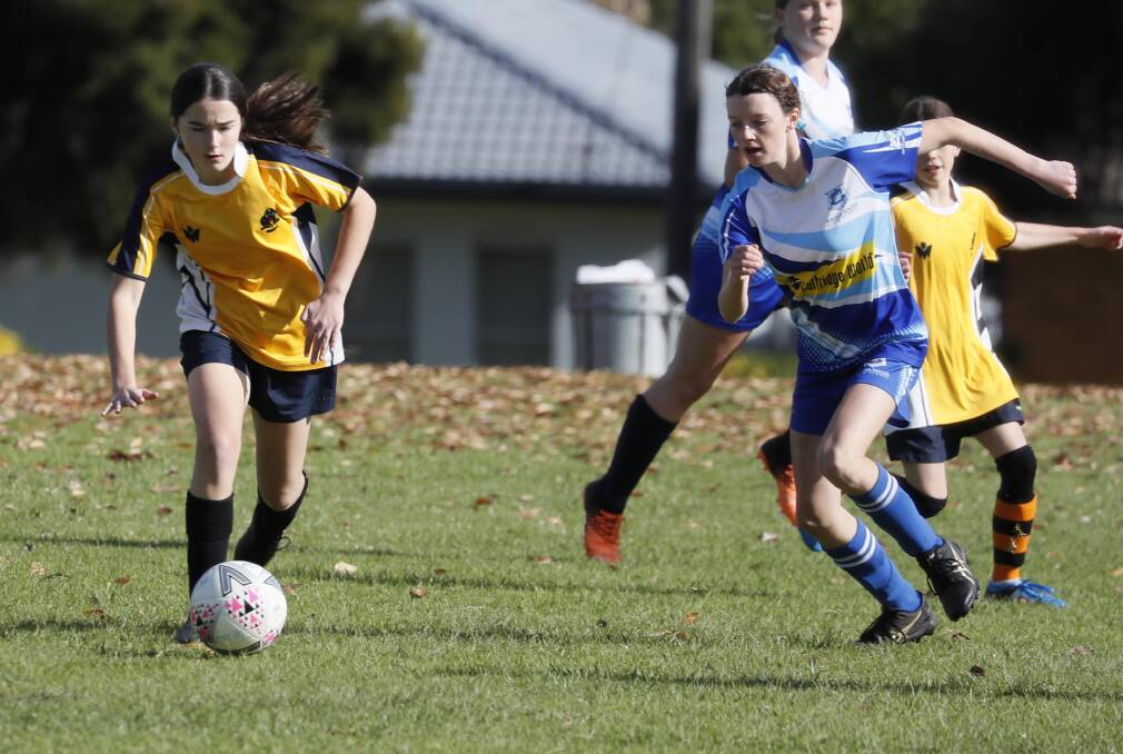 IN PURSUIT: Kooringal High School's Stella Grentell looks to get away from Wagga High School's Matilda Cole in the Ron Anschuetz Shield soccer at Kessler Park on Friday. Picture: Les Smith