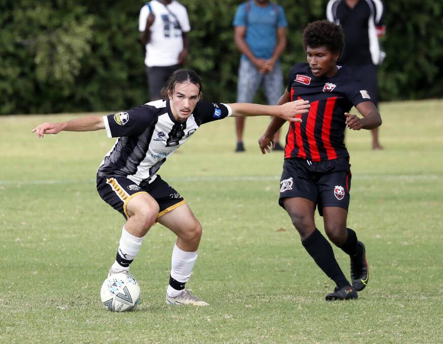 STRONG START: Wagga City Wanderers' Samson Lucas looks to keep the ball away from Leeton United's Junior Fomani in the pre-season trial game at Gissing Oval on Saturday. Picture: Les Smith