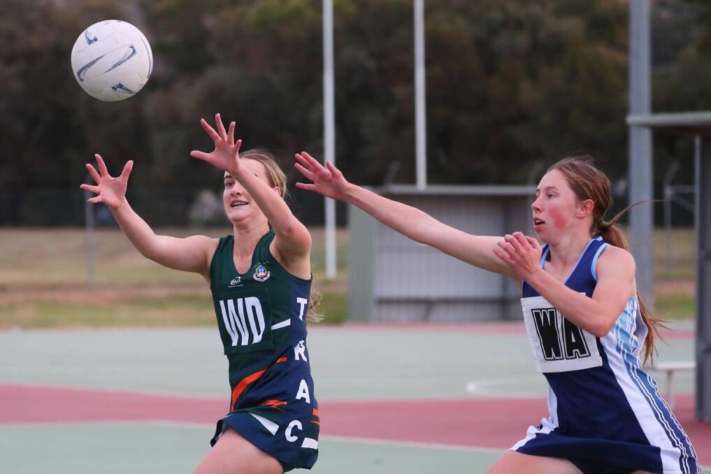 EYE ON THE PRIZE: The Riverina Anglican College's Sarah Crocker looks to win possession of the ball despite close attention from Wagga High School's Alice Trevaskis in the Tracey Gunson Shield semi-final on Monday. Picture: Emma Hillier