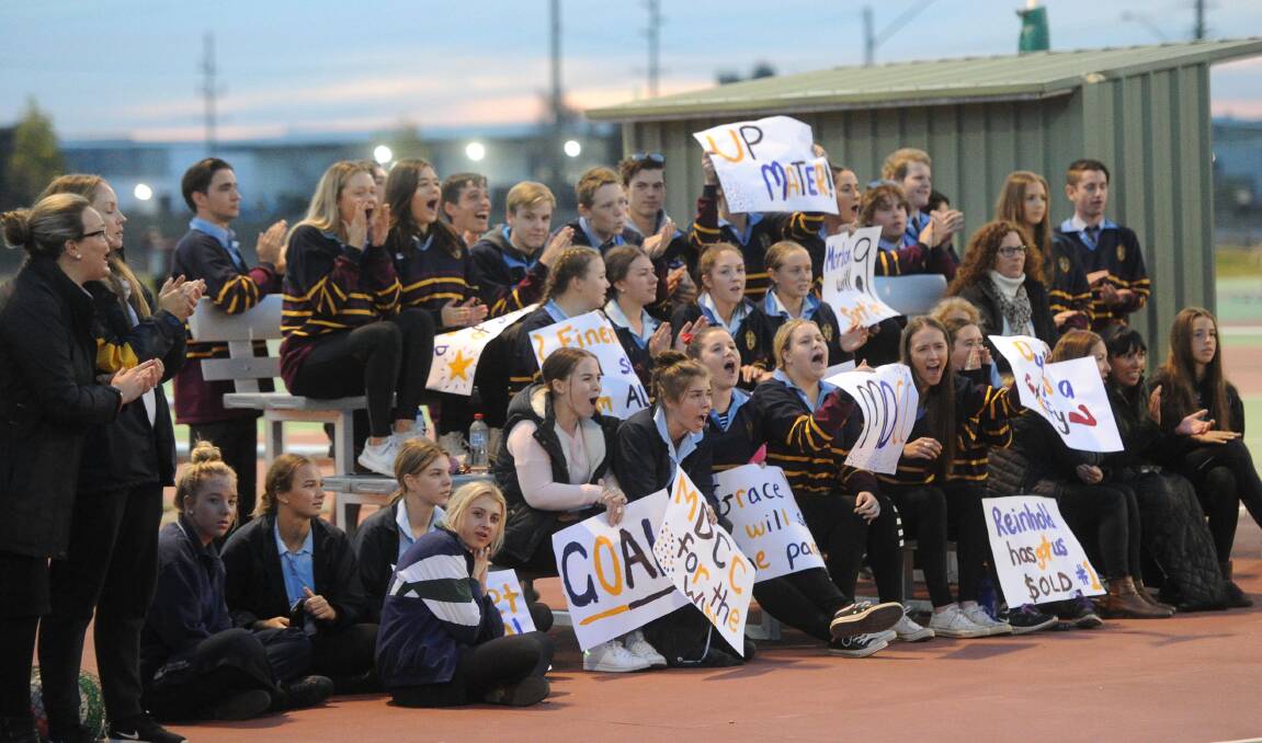 RIVALRY: Mater Dei Catholic College students get behind their team against Kildare Catholic College at last year's netball final.