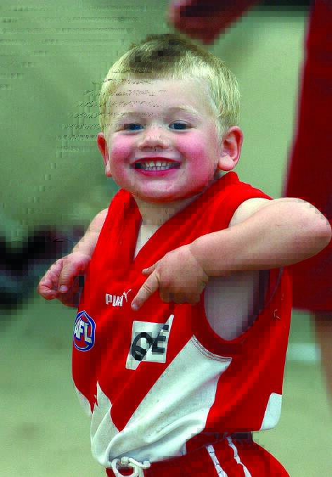 Two-year-old Jack Rowston supporting his dad, Phil, back on 2002 Riverina League grand final day.