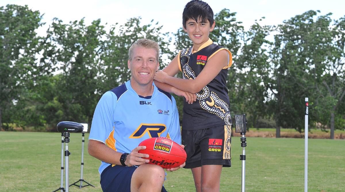 TALENT HUNT: AFL NSW-ACT consultant Tim Schmidt with Wagga 12-year-old Charlie Carey at the Clontarf AFL carnival at Jubilee Park on Thursday. Picture: Kieren L Tilly