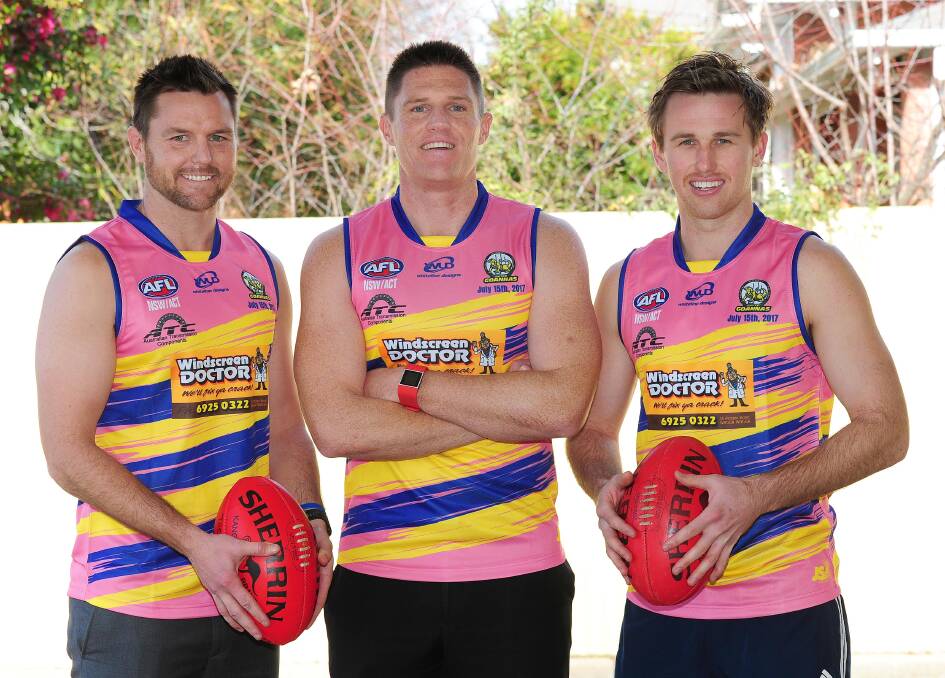 GOOD CAUSE: Mangoplah-Cookardinia United-Eastlakes' Trent Cohalan, Travis Cohalan and Ryan Price show off the guernseys the Goannas will wear against Wagga Tigers on Saturday. Picture: Kieren L Tilly