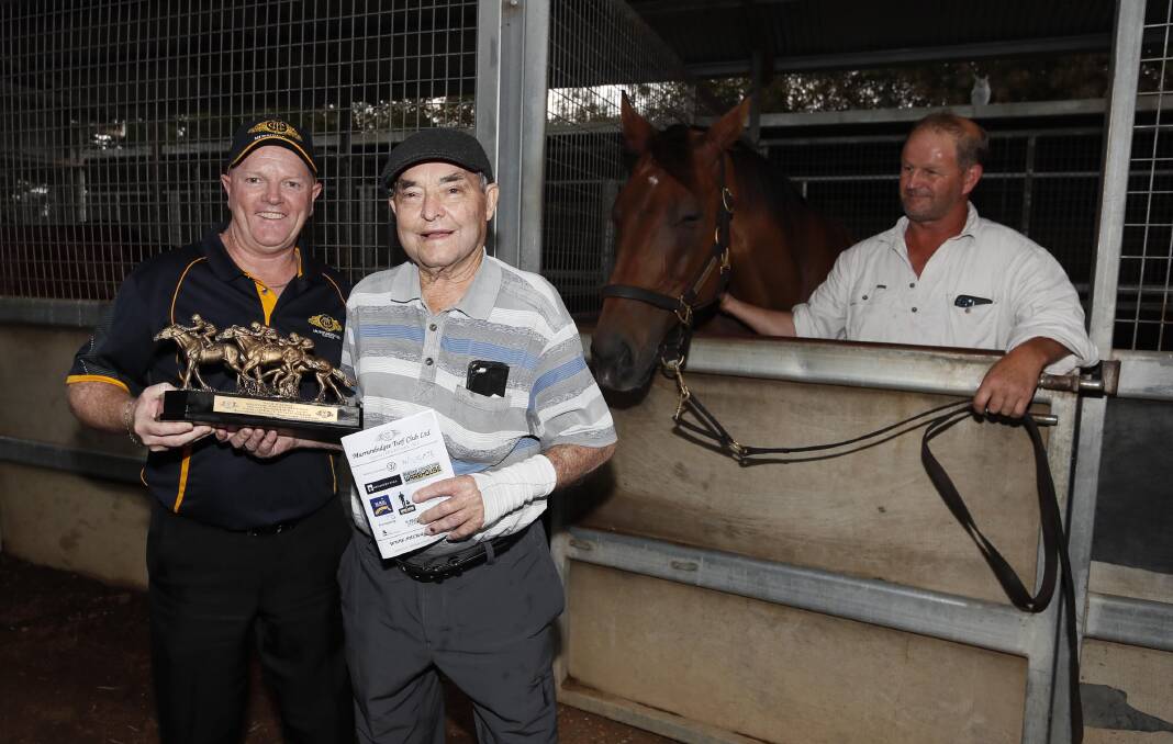 SPECIAL MOMENT: Murrumbidgee Turf Club chief executive Jason Ferrario presents the winning trophy to part-owner Mick Rudd, with Landmine and trainer Chris Heywood watching on. Picture: Les Smith