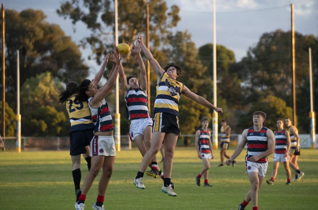 UP FOR GRABS: Kooringal High School's Jonathan Mulhearn and Seb Rodet compete with Kildare Catholic College's Nick Madden and Tom Nejman in the Carroll Cup game at Gumly Oval on Monday. Picture: Madeline Begley
