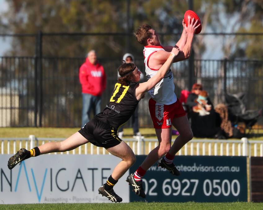 MAKING HIS MARK: Griffith's Jacob Conlan takes a mark despite the best efforts of Wagga Tigers' Xavier Lyons at Robertson Oval on Saturday. Picture: Emma Hillier