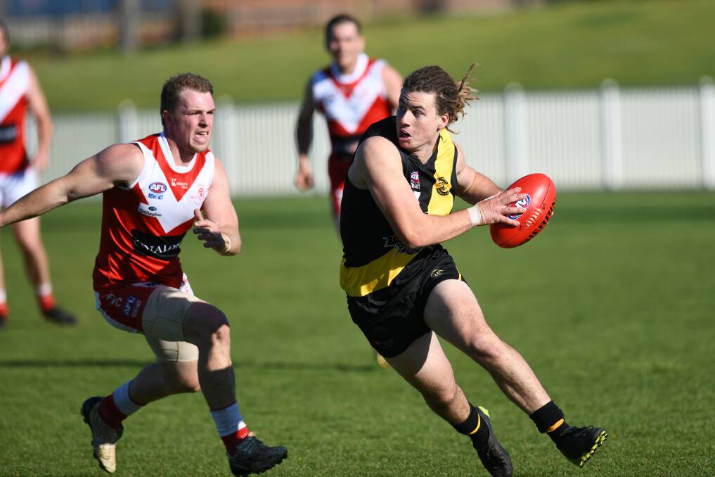 ON THE RUN: Wagga Tigers' Ashley Bennett tries to evade Collingullie-Glenfield Park's Jason Ainsworth in the Riverina League game at Robertson Oval on Saturday. 