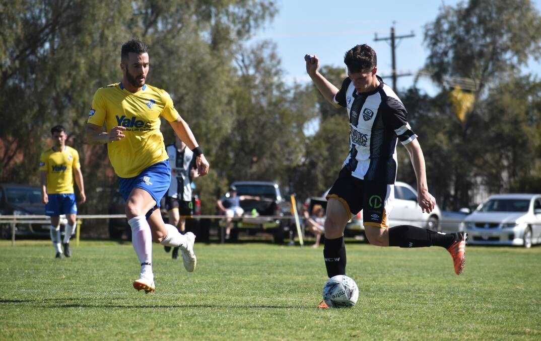 LOCAL DERBY: Wagga City Wanderers' Luke Stevens sends the ball forward against Yoogali at E W Moore Oval in Griffith on Sunday. Picture: Liam Warren