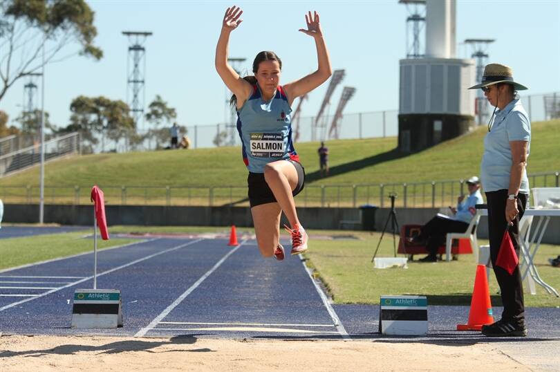 NUMBER ONE: Carly Salmon flies through the air at the NSW All Schools Carnival at Homebush. Picture: David Tarbotton